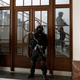 Prison guards walks outside a courtroom during an appeal by Yevgeniy Nikulin from Russia who faces charges of hacking computers of American companies on Nov. 24, 2017, in Prague, Czech Republic
